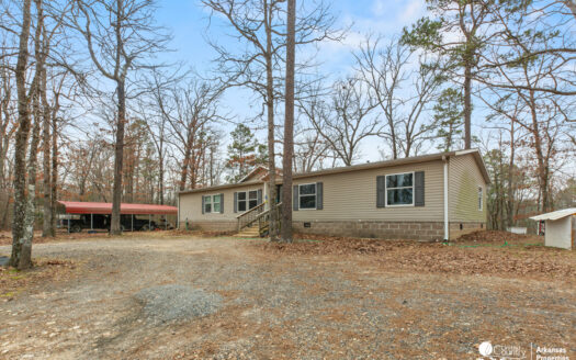 Nestled on nearly 6 wooded acres south of Mena near Wolf Pen Gap