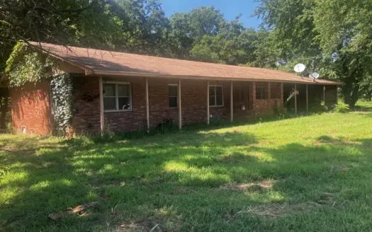Fixer Upper on Two Beautiful Acres with Paved Road Frontage.