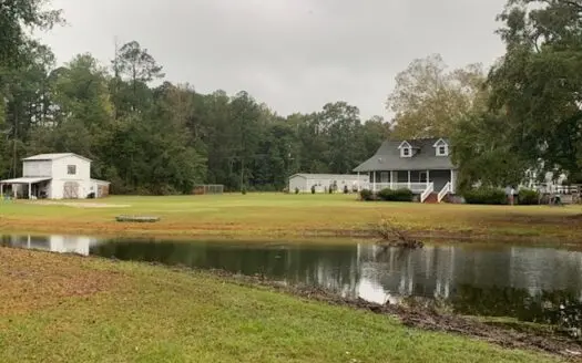 5.1 Acres with a stocked pond , Near town but in the country